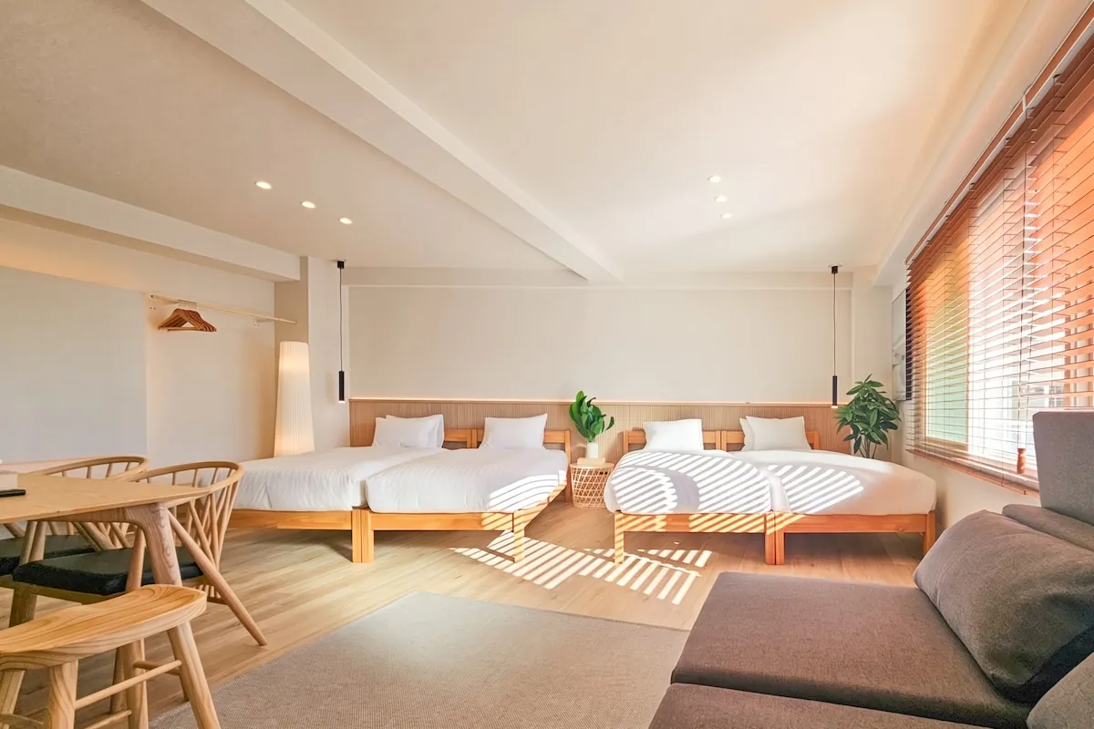 Sunlit family apartment with four single beds and a dining table at STAY ARI Arakicho A